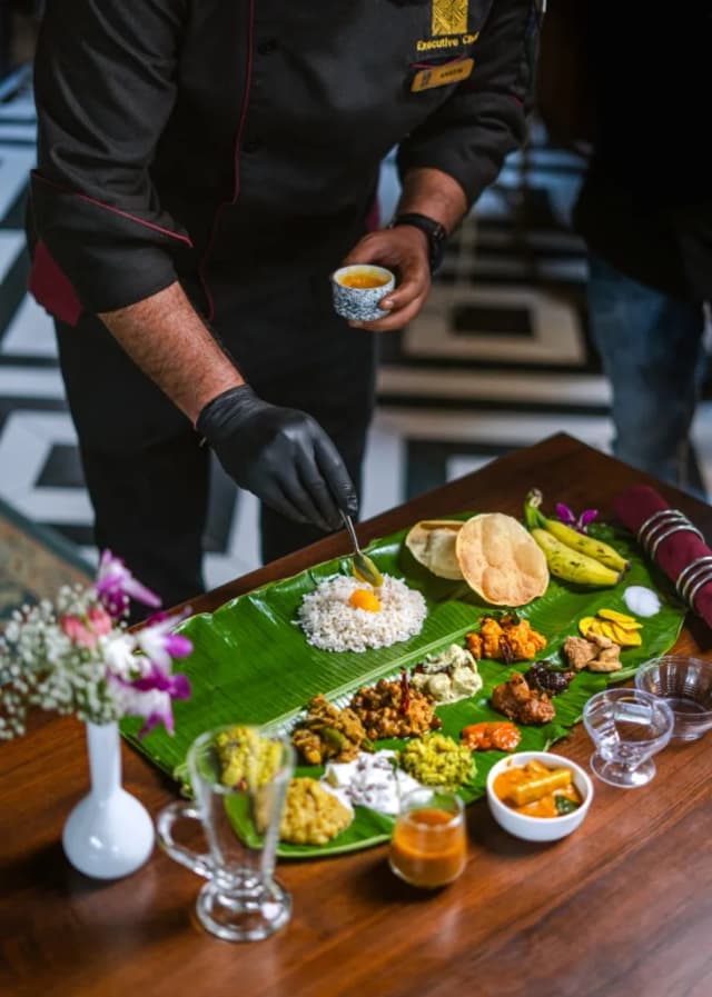 Adithya Catering Kitchen's culinary team preparing an Onam Sadhya spread